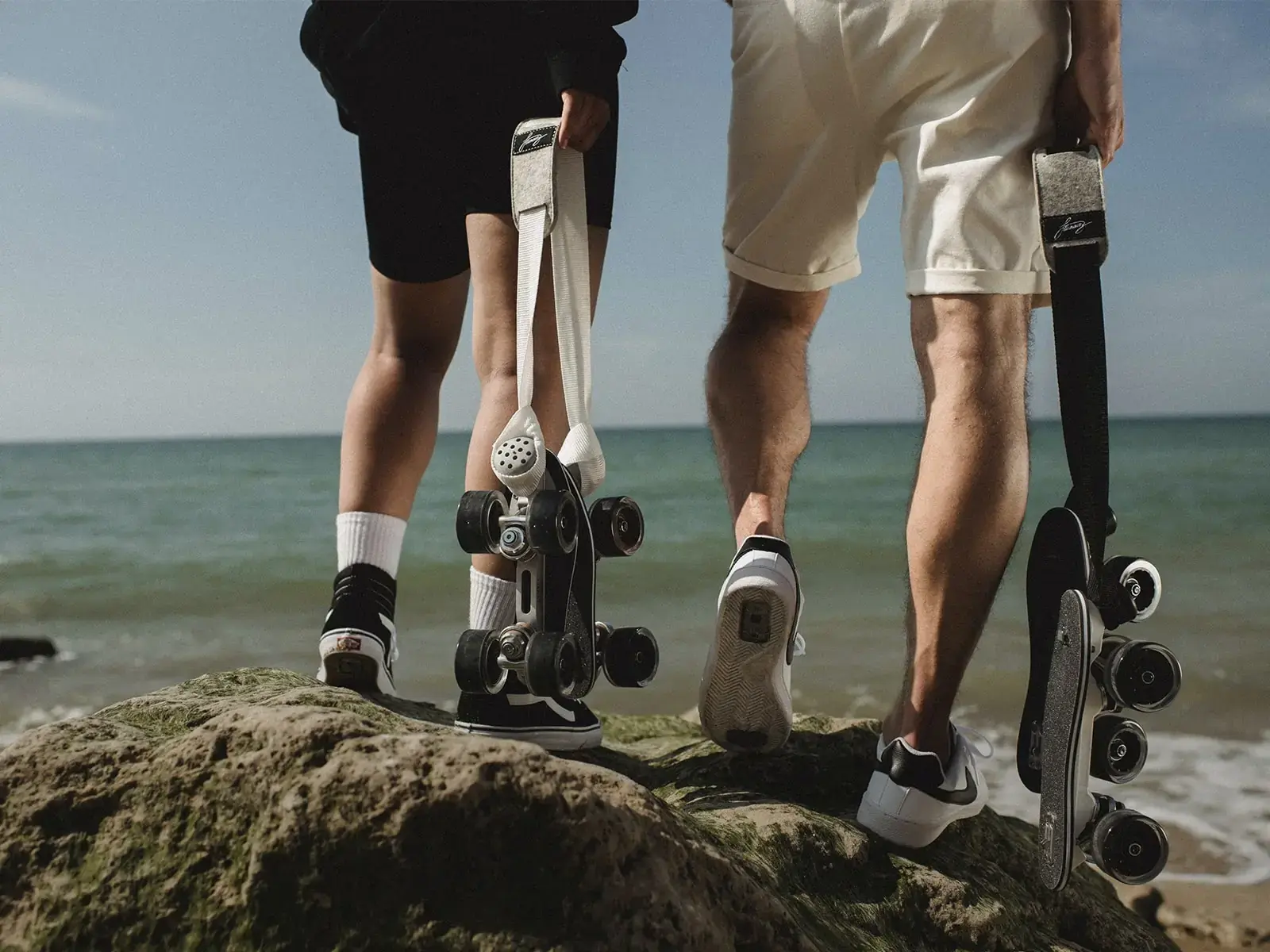 a man and a woman wearing their transformed vans and nike and holding their rolling parts by flaneurz