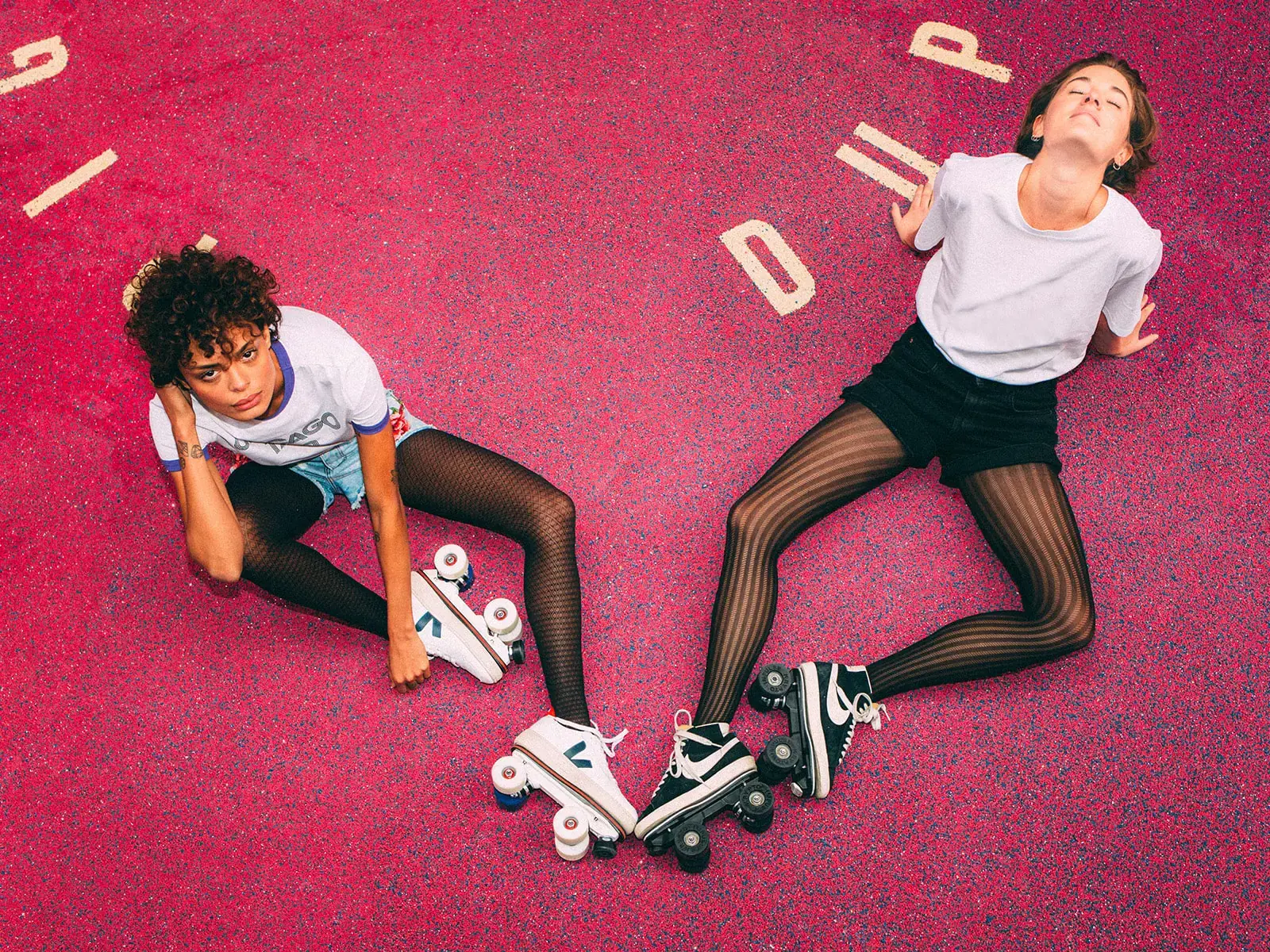 Two girls wearing their roller skates veja and nike