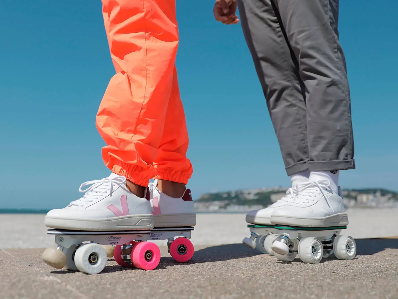 2 people  wearing roller skates