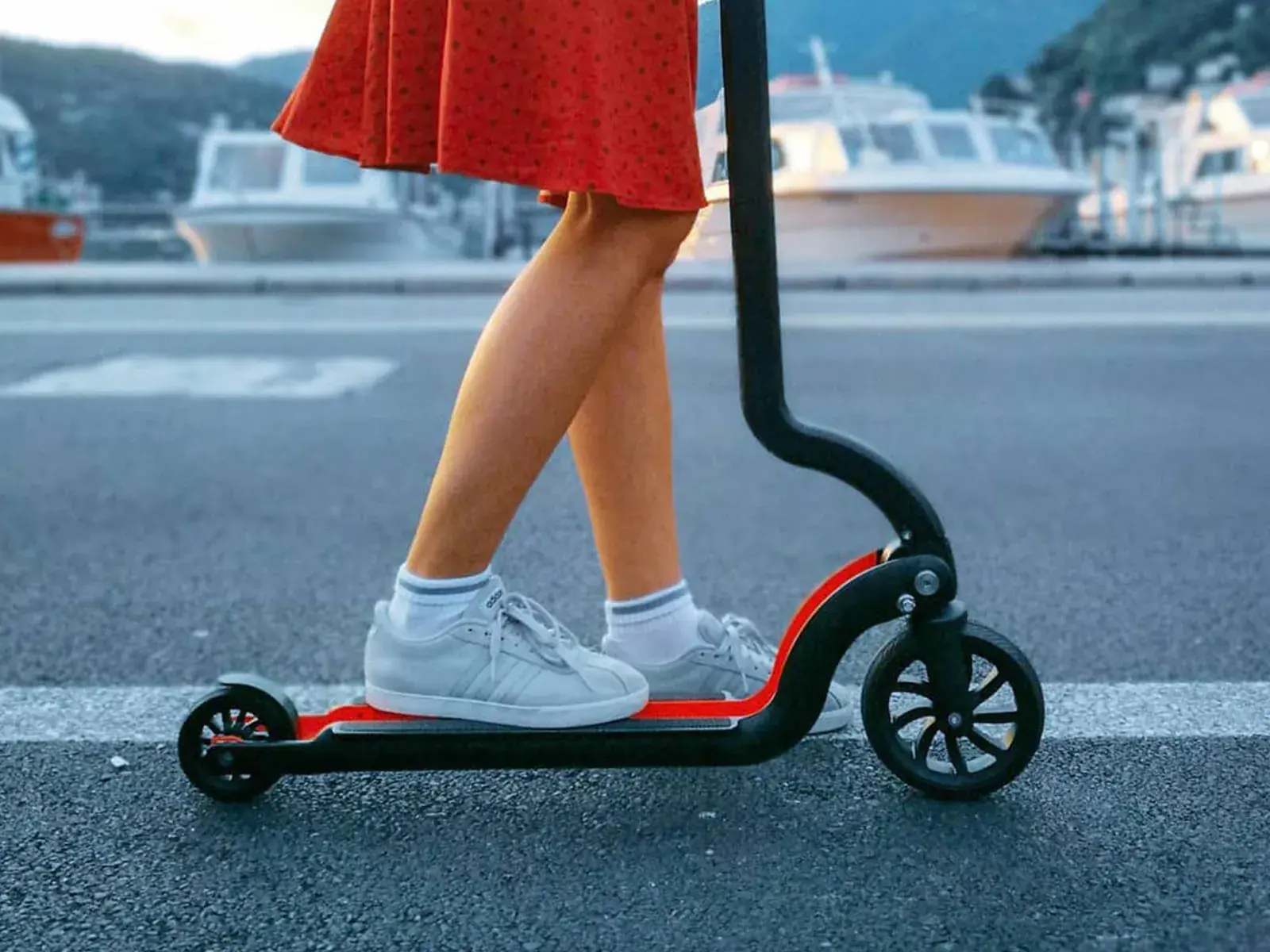 a girl using trotinette for transporting 