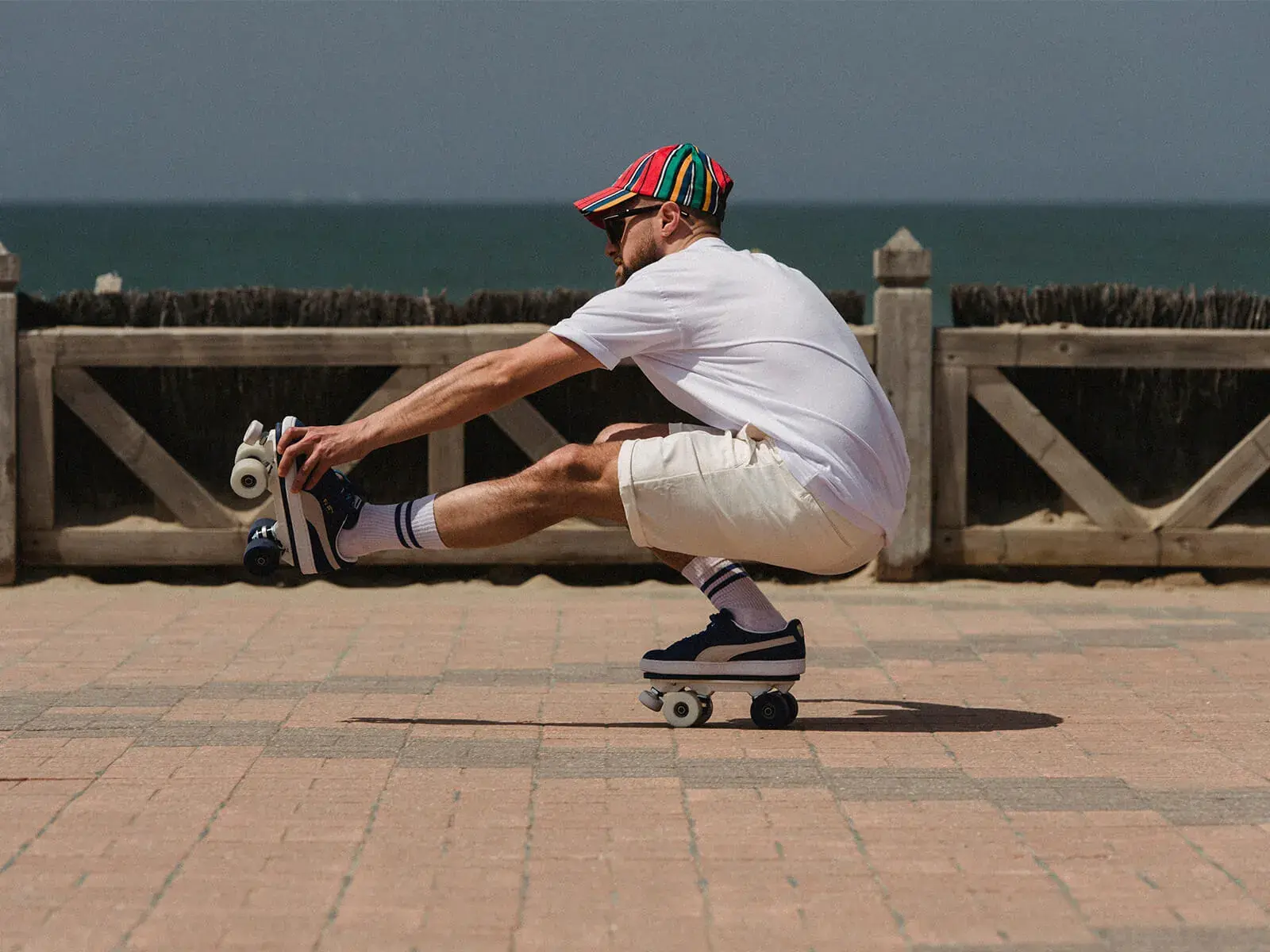 a man using his skating sneakers beside the beach