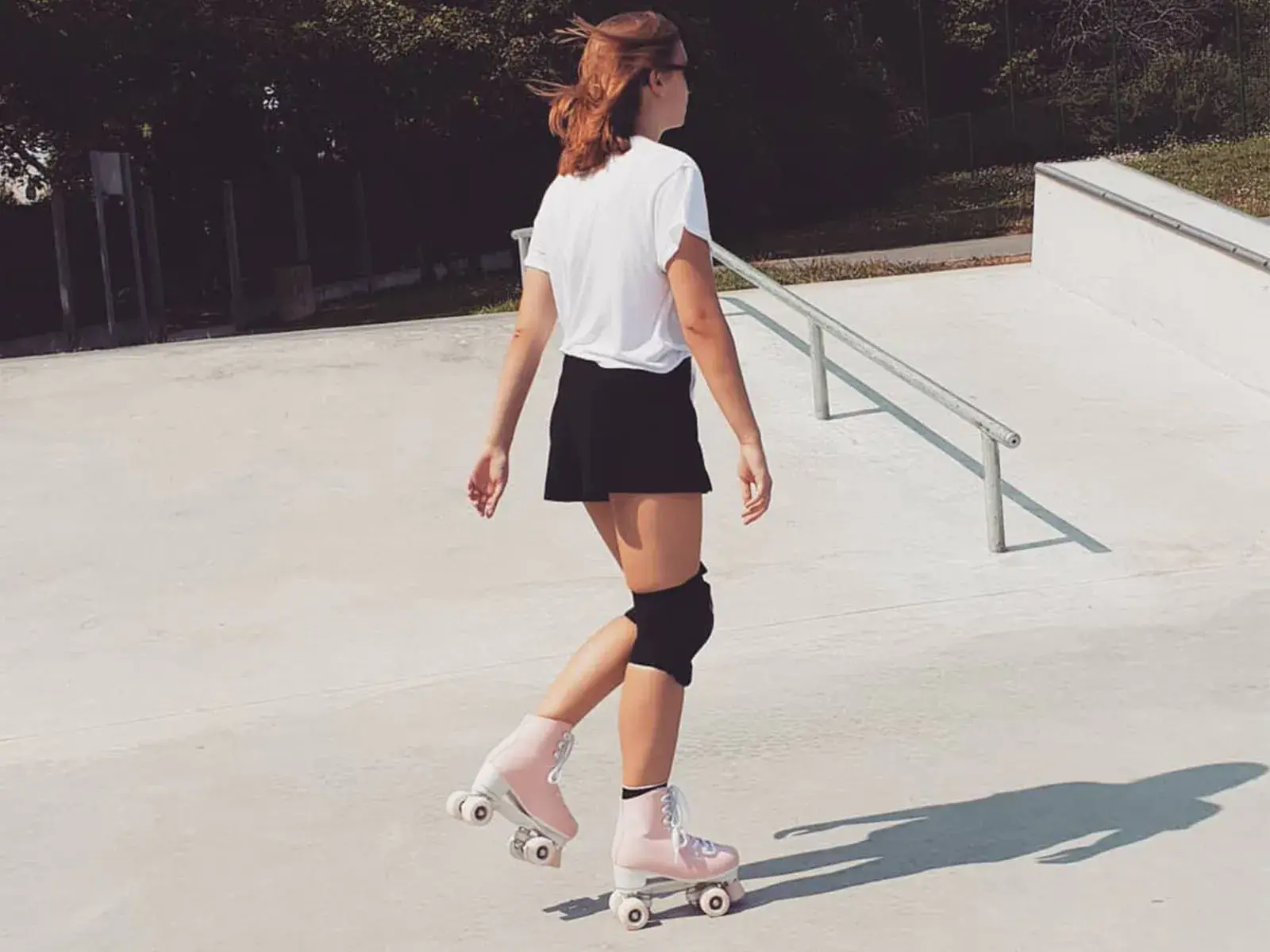 a girl skating with her pink roller skates