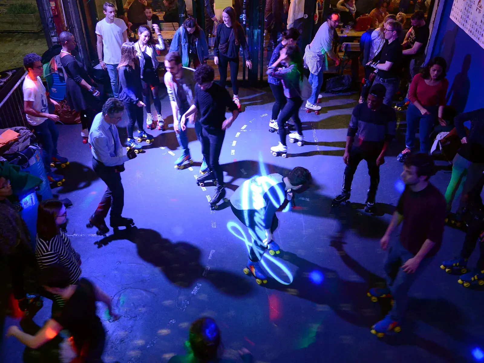 roller skating party with people dancing around 