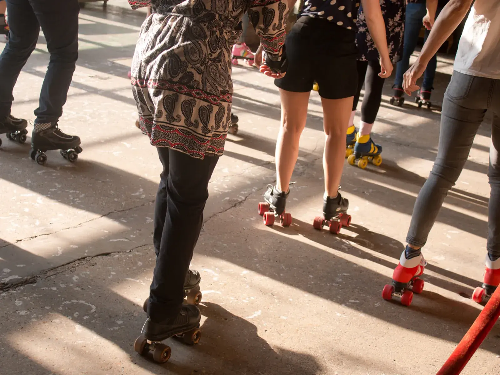 group of people wearing roller skates and skating together 10