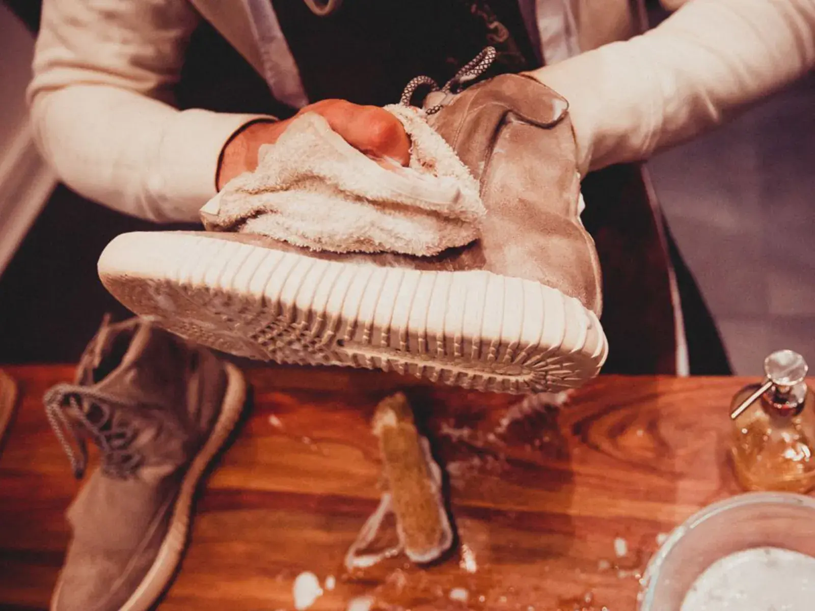 a man cleaning a sneaker