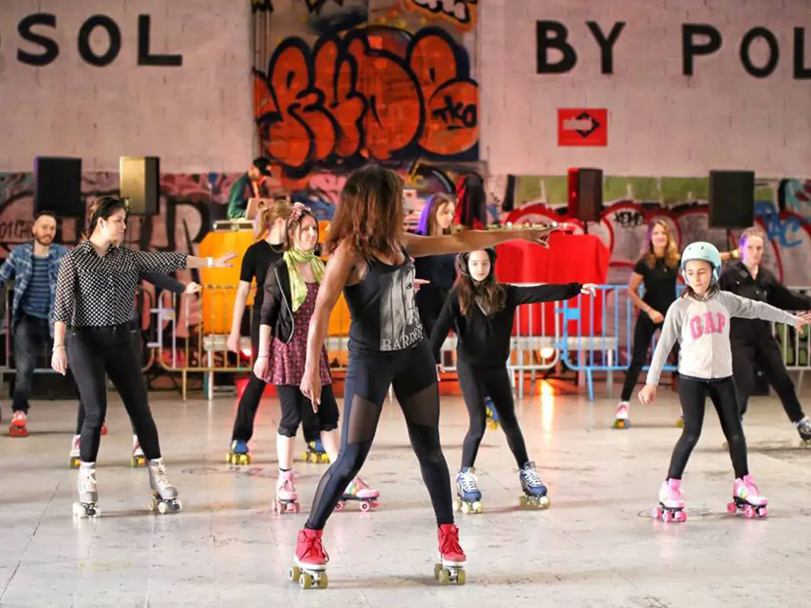 Laurence teaching other people how to skate and dance wearing roller skates by flaneurz