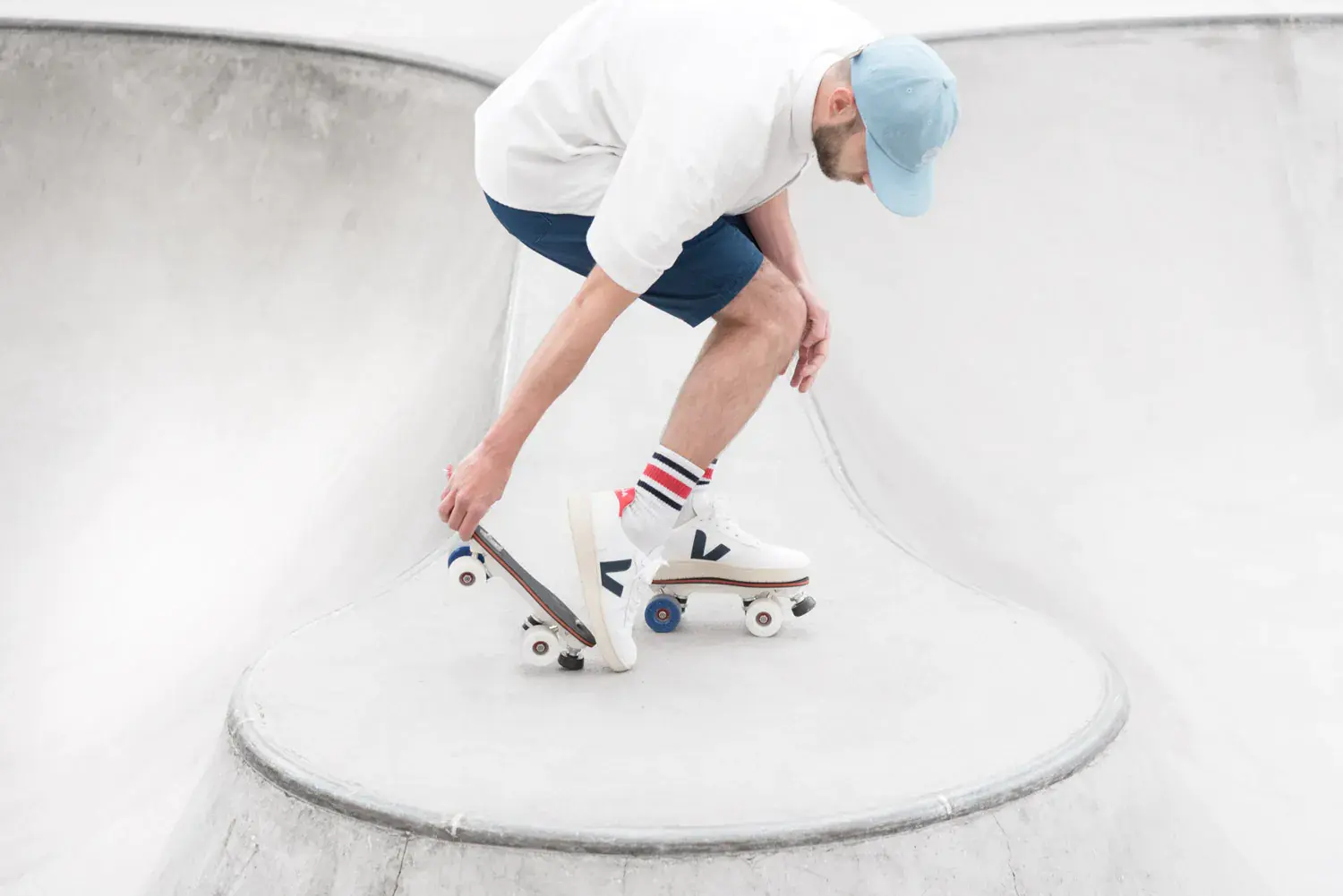a man wearing white veja roller skate by flaneurz for the unfolllow collection