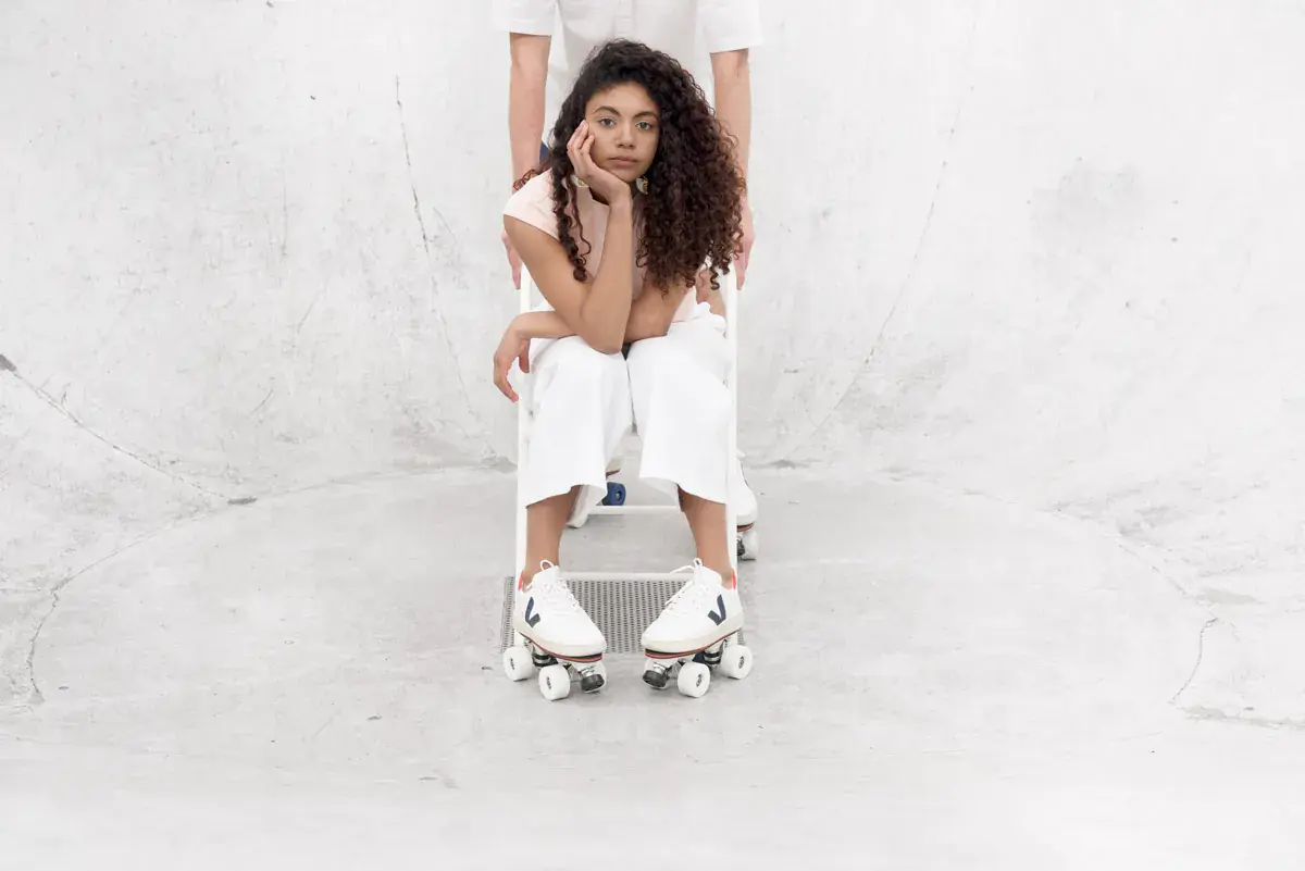 a woman wearing white veja transformed to roller skate by flaneurz