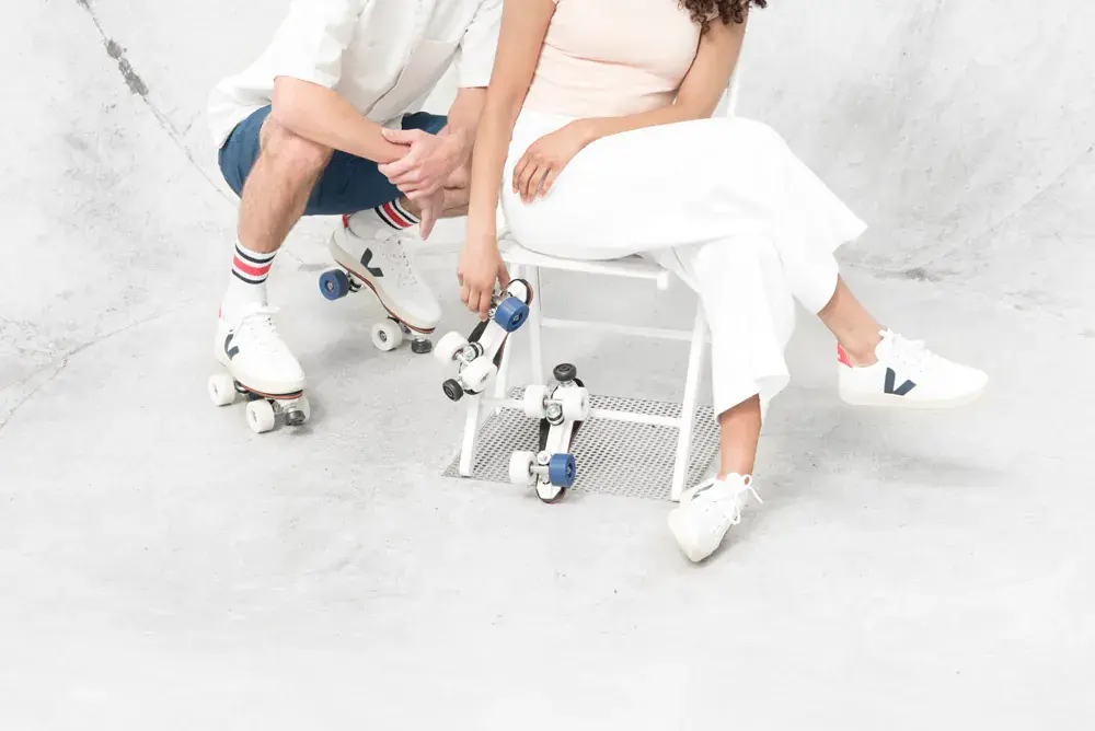 a man and a woman wearing white veja sneakers transformed by flaneurz for the unfollow collection