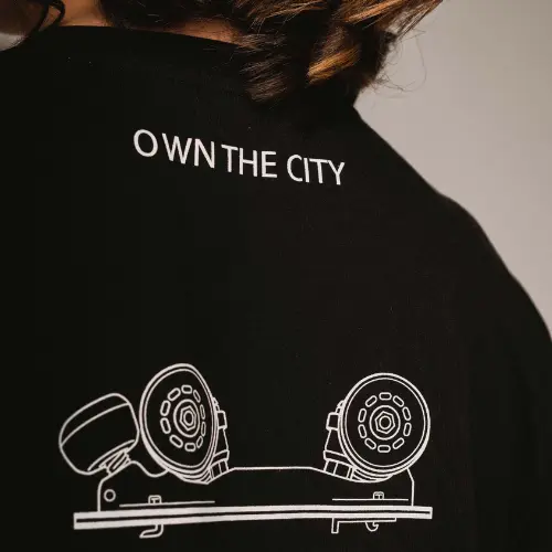 T-shirt-Black-Flaneurz-own-the-city a girl wearing a black t hsirt flaneurz own the city from the back