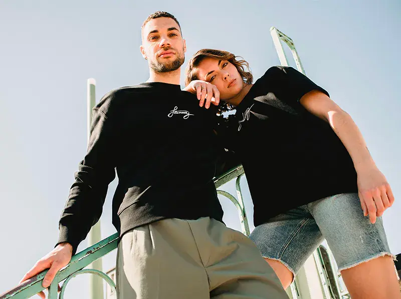 a man and a woman wearing Flaneurz black Tshirt 