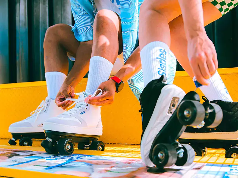 a man and a woman wearing their roller skates SLADES 