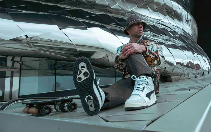a man sitting with his transformed sneakers and his rolling parts flaneurz