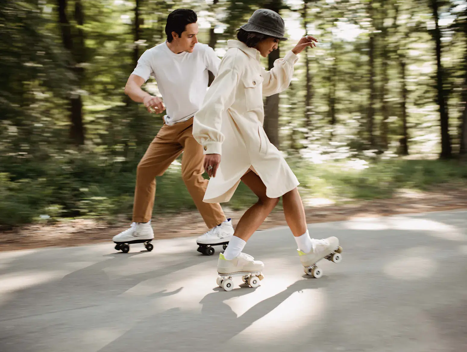 a man and a woman skating on the road