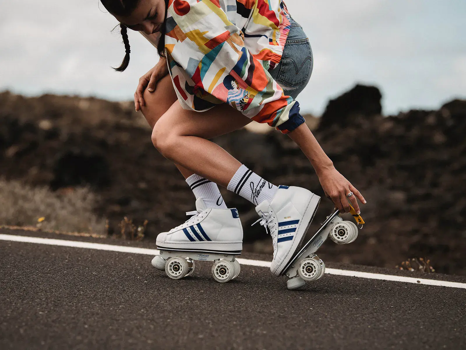 a woman wearing roller skates adidas in the road