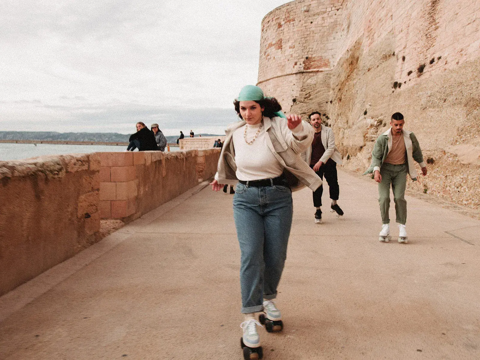 a woman skating in the city beside the beach
