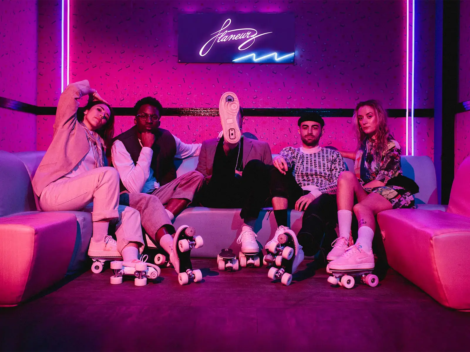 a group of people sitting on a sofa and wearing S-Quad Slades by flaneurz
